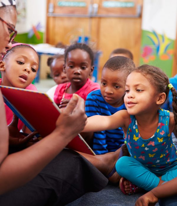 Teacher reading a book with a class of preschool children